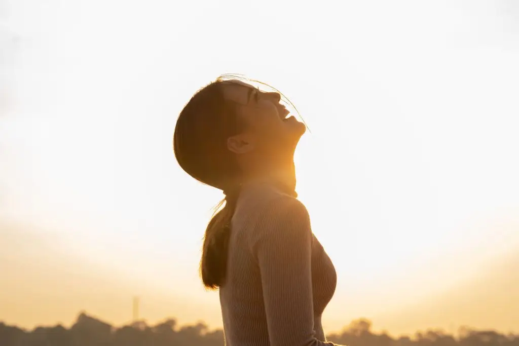 Laughing woman with the sunset in the background