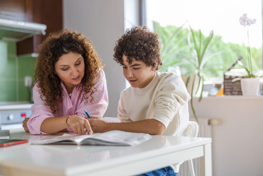 Parent helping child at home with school work